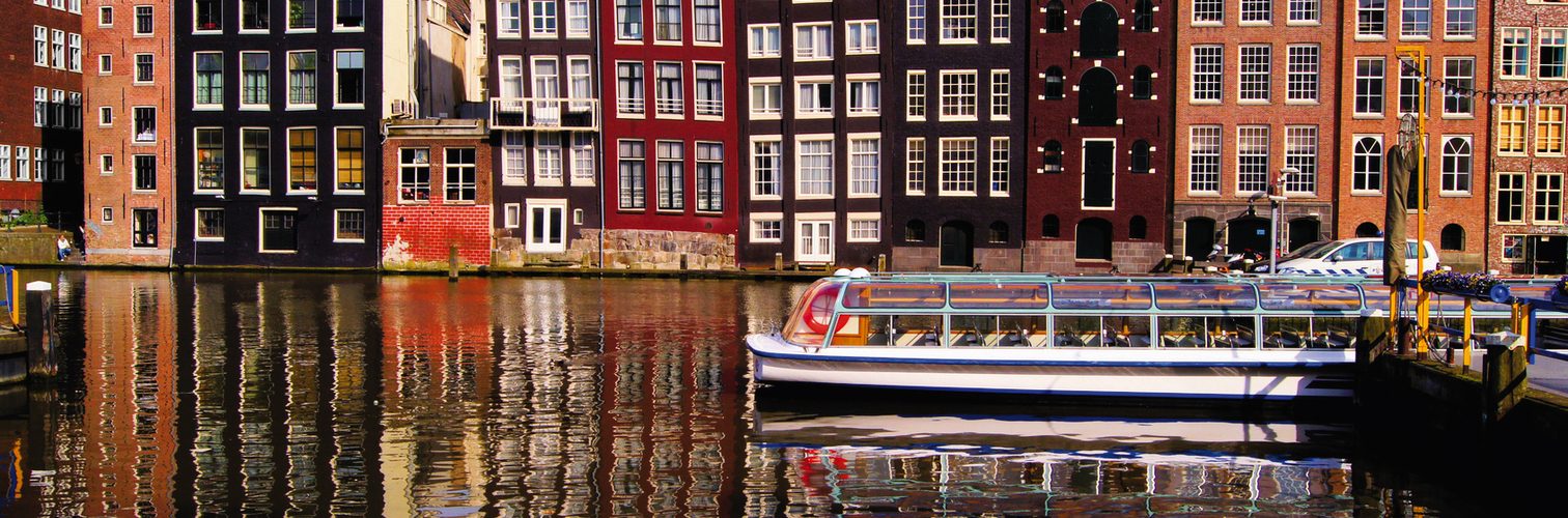 Traditional houses of Amsterdam with canal reflections
