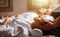 Young couple receiving head massage at beauty spa