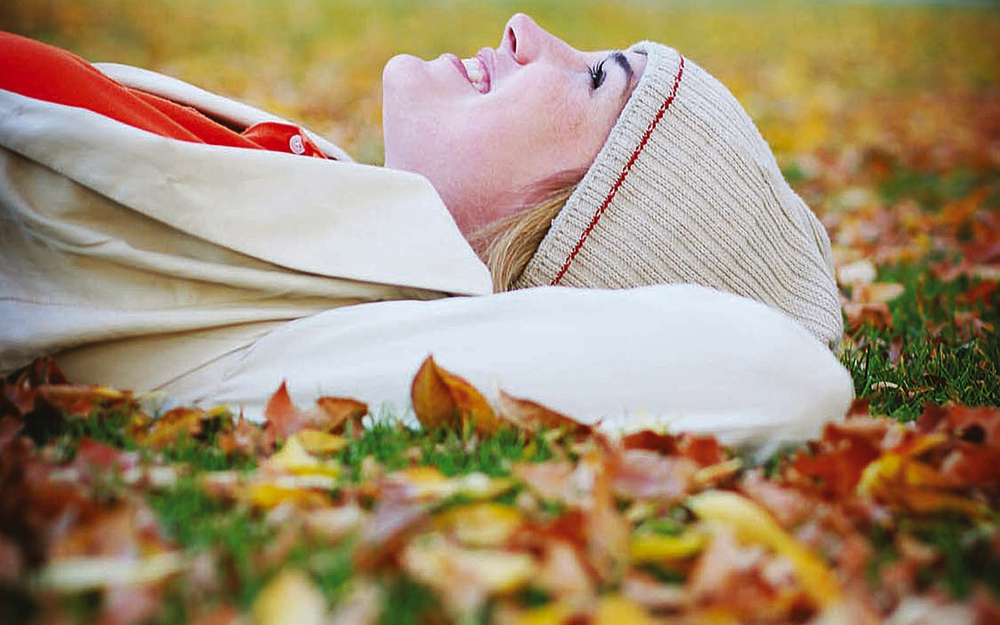 woman lying in leaves