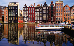 Traditional houses of Amsterdam with canal reflections
