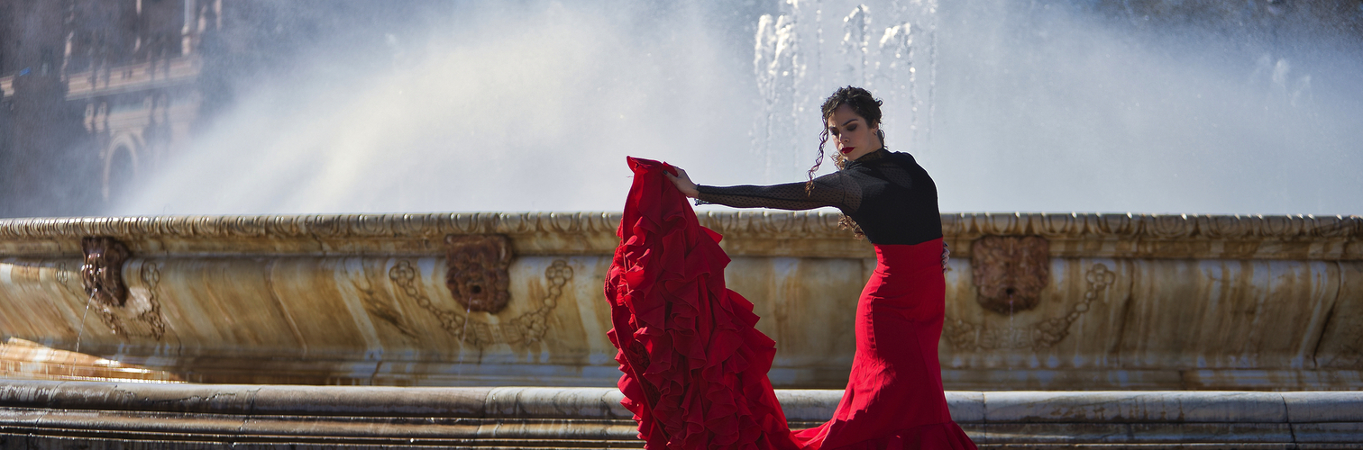 Flamencotänzerin vor einem Brunnen auf dem Spanischen Platz in Sevilla